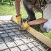 man building a cobblestone entryway during a home renovation