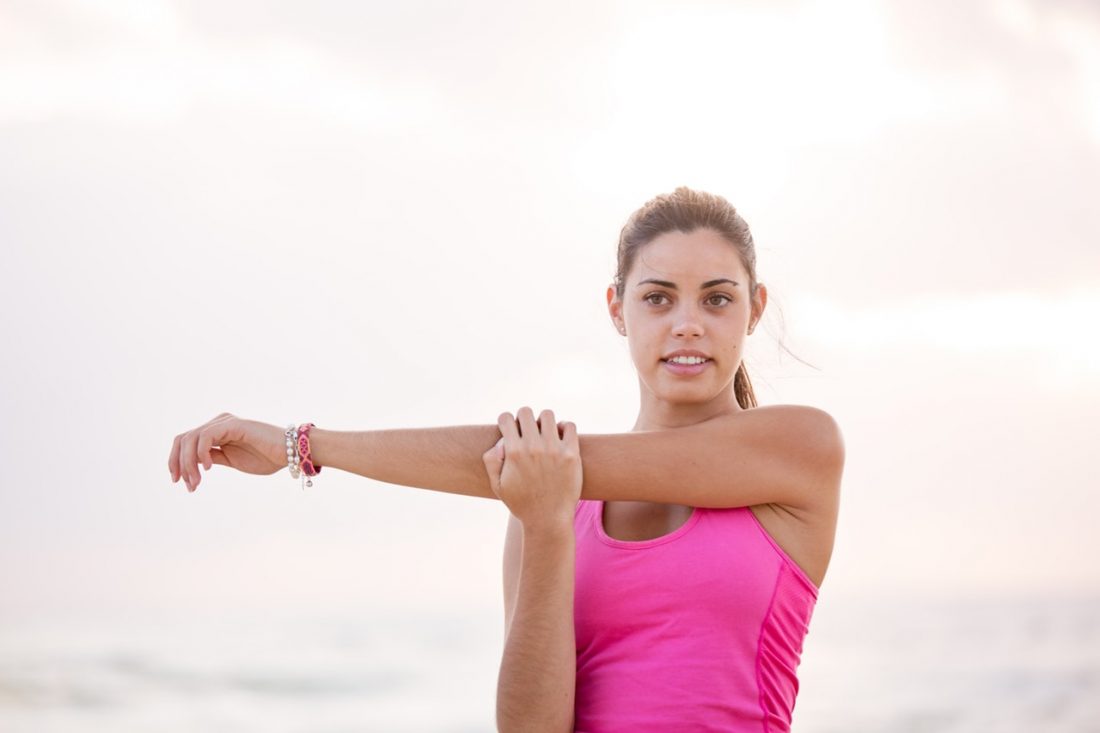 Woman stretching her arm.